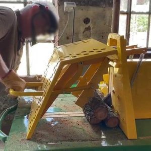 Carpenter uses the circular saw to cut firewood